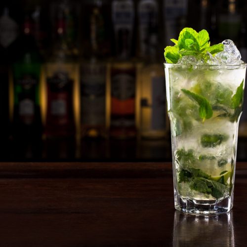 Classic Mojito Coctail on wooden bar.